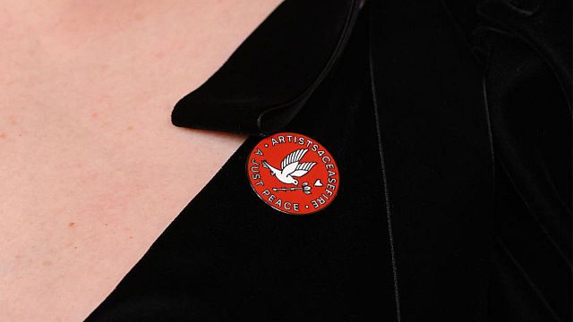 Imagem da notícia O que significa o pin vermelho no Oscar 2026? Atriz de Bridgerton e outros artistas se manifestam na cerimônia